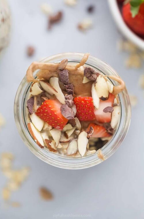 A close-up shot of a jar of vanilla almond overnight oatmeal shown from above