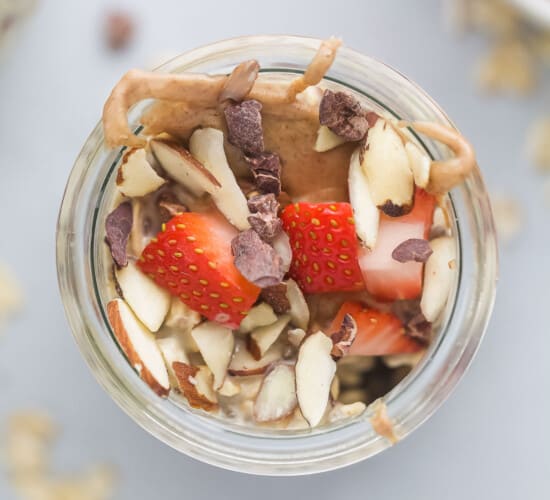 A close-up shot of a jar of vanilla almond overnight oatmeal shown from above