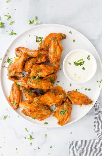 A plate of Air Fryer buffalo wings with a small dish of ranch beside them