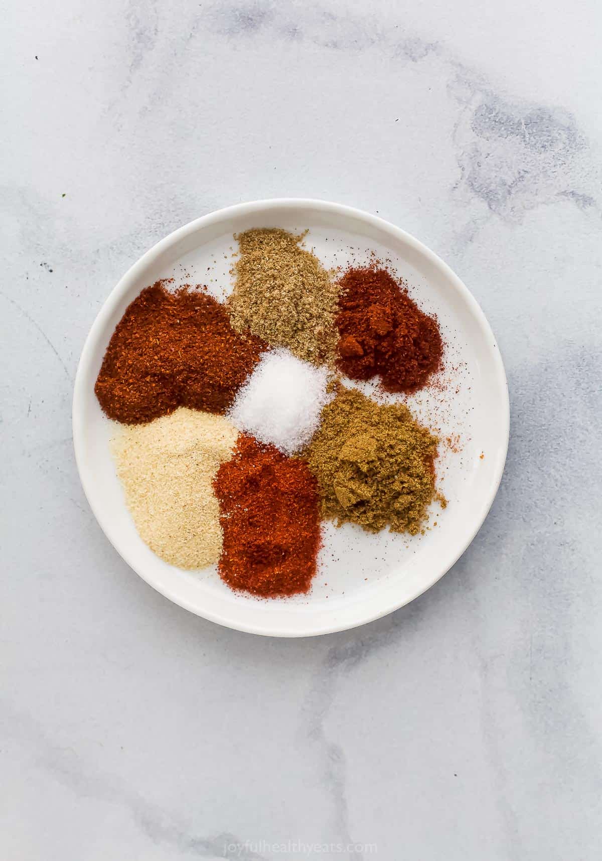 Different spices on white plate