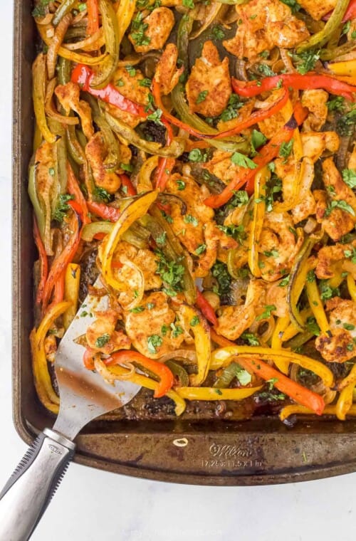 Close-up of sheet pan chicken fajitas on a baking sheet