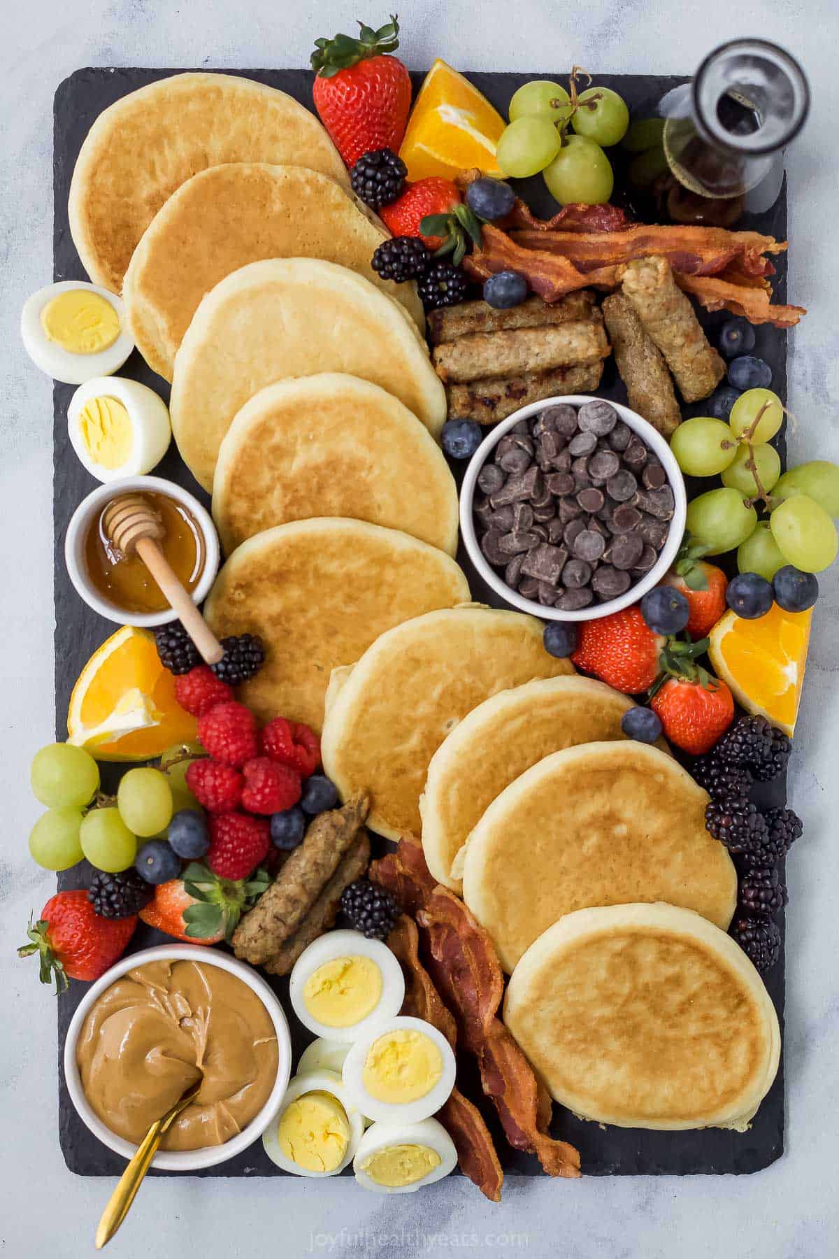 A brunch charcuterie board on top of a marble kitchen counter