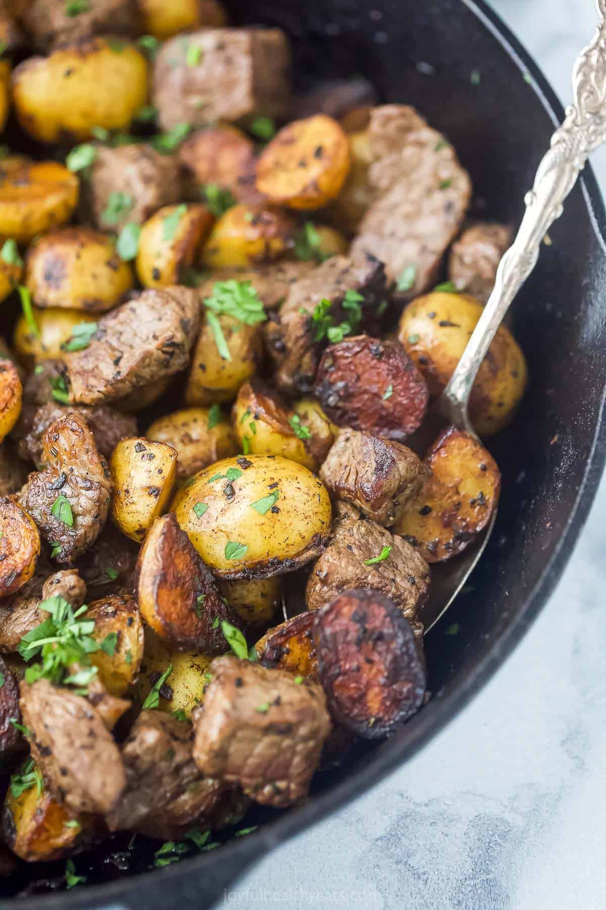 garlic steak and potatoes in a skillet