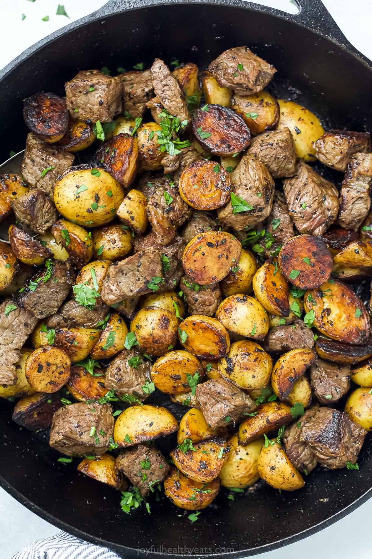 Close up of garlic butter steak and potato skillet