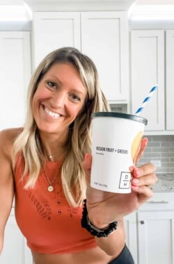 girl holding a daily harvest smoothie