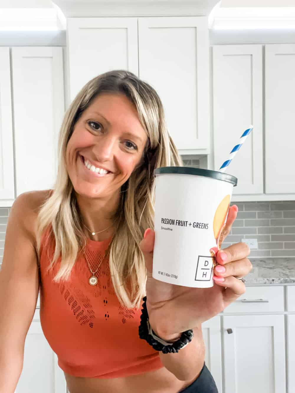 girl holding a daily harvest smoothie