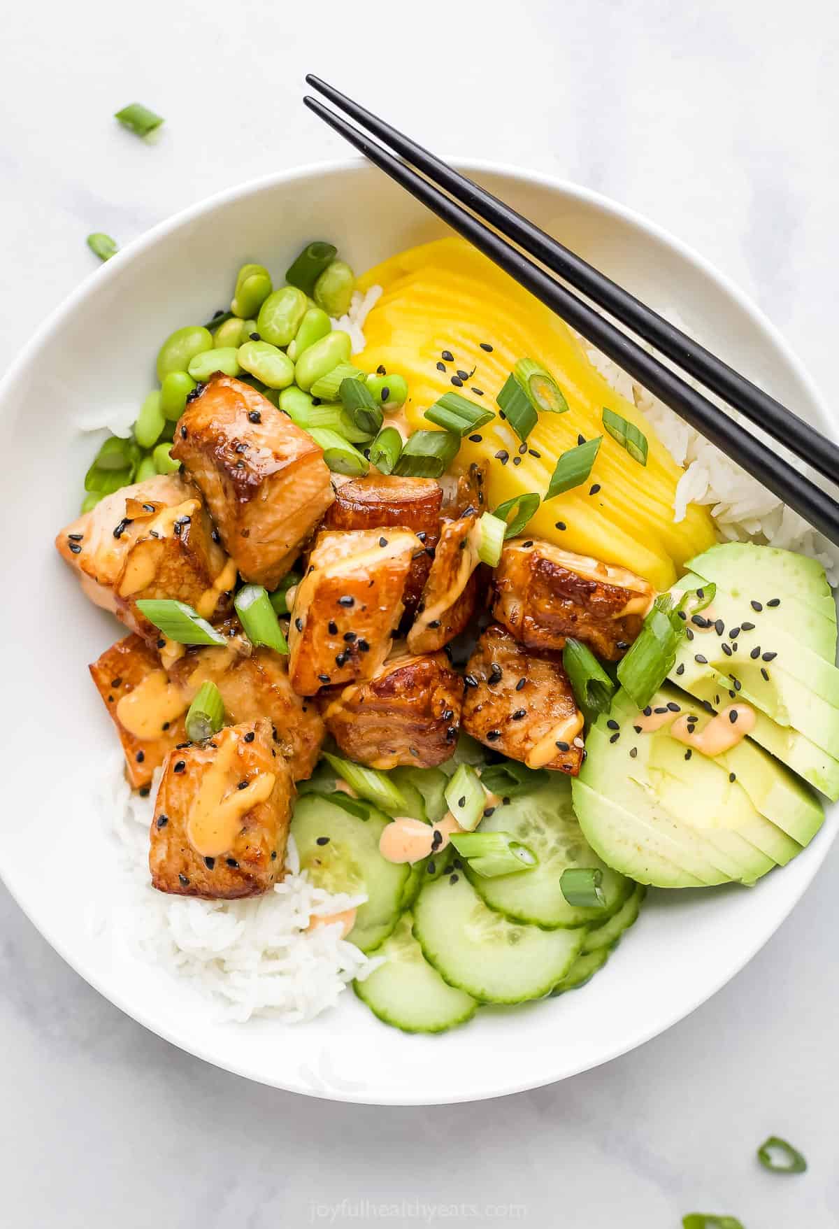 Here's a round-up of my top 20 Healthy Salmon Recipes. You're bound to find something for everyone on this list! A close-up shot of a rice bowl with fish, mango, avocado, cucumber and more