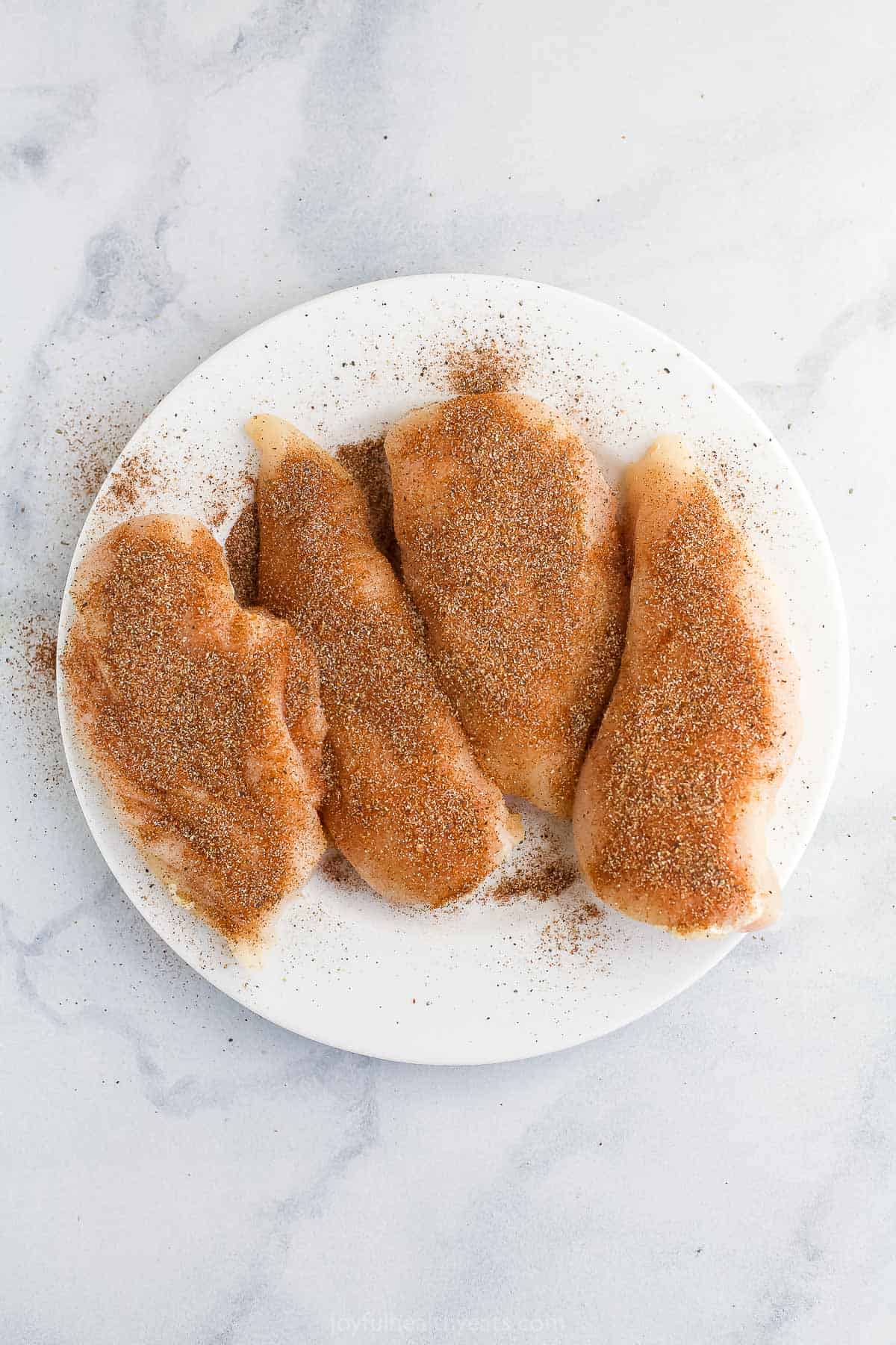 Chicken breasts with chipotle spice rub on a white plate