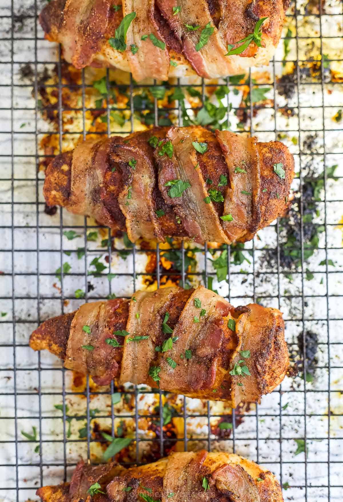 Overhead view of bacon wrapped chicken breasts on a baking sheet