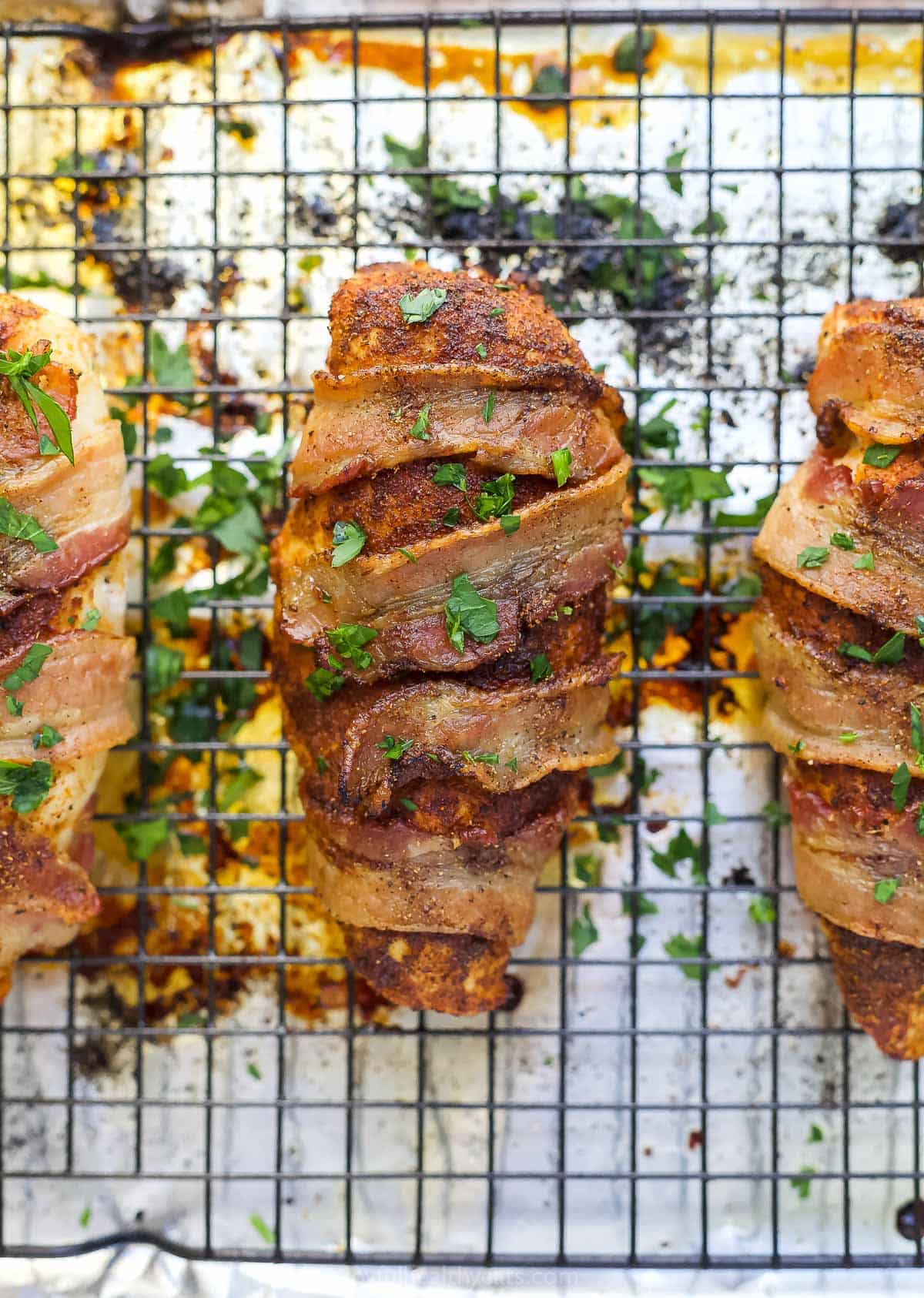 Overhead view of bacon wrapped chicken breasts on a baking sheet