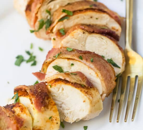 Close-up of slices of bacon wrapped chicken breast on a plate