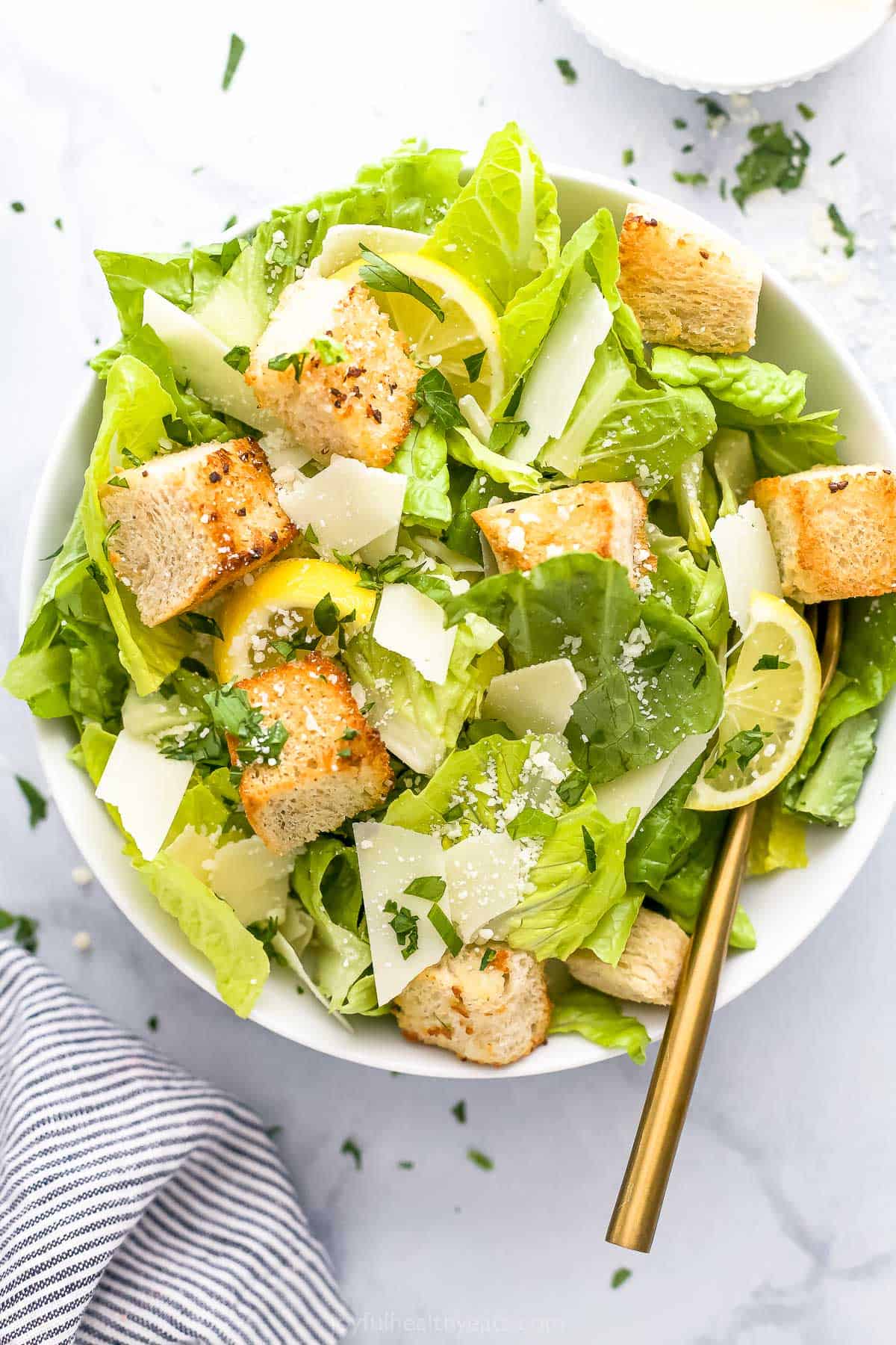 A close-up shot of a bowl of homemade caesar salad