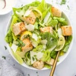 Homemade caesar salad in a bowl on a marble countertop