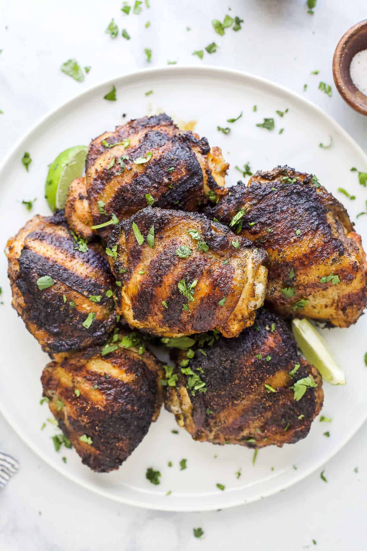 spice rubbed grilled chicken thighs on a plate