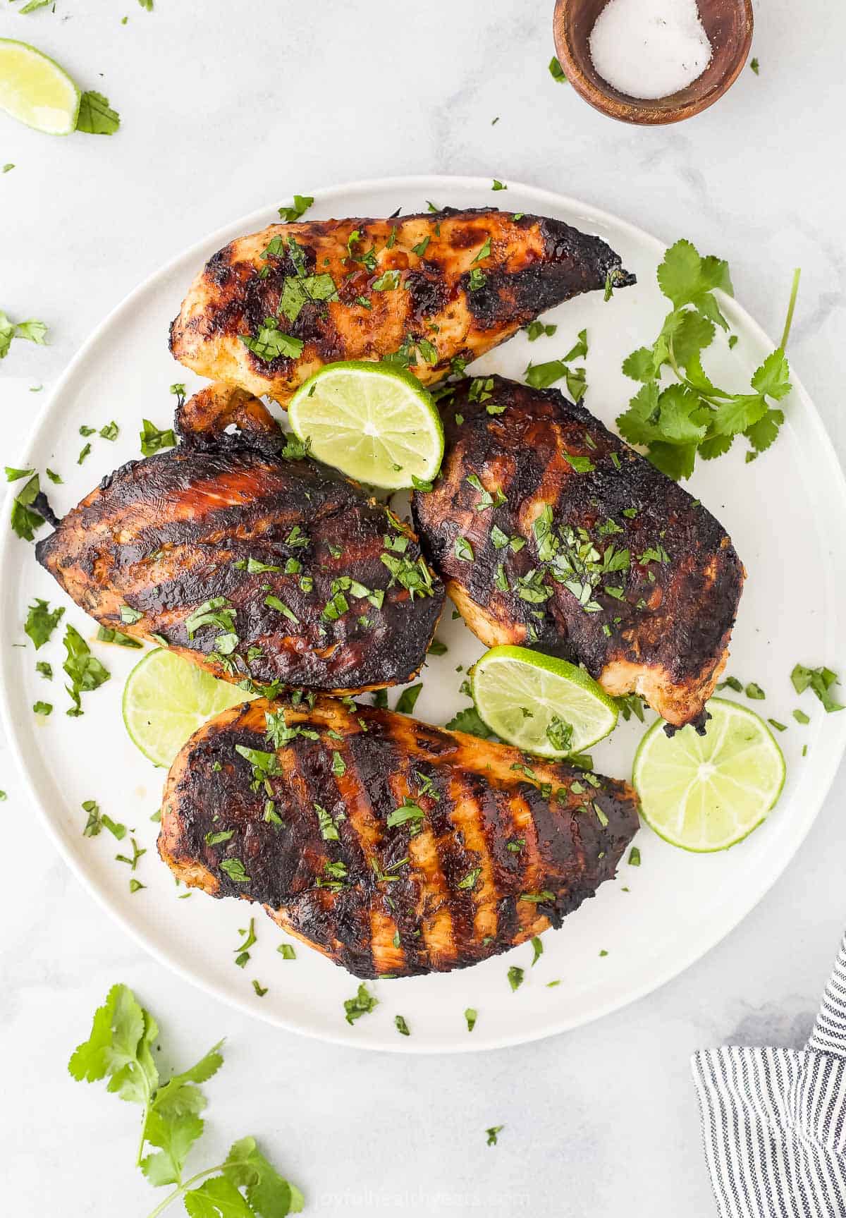 A plate of tequila lime chicken on a marble countertop