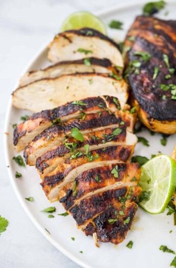 Tequila lime grilled chicken on a plate with chopped parsley sprinkled on top