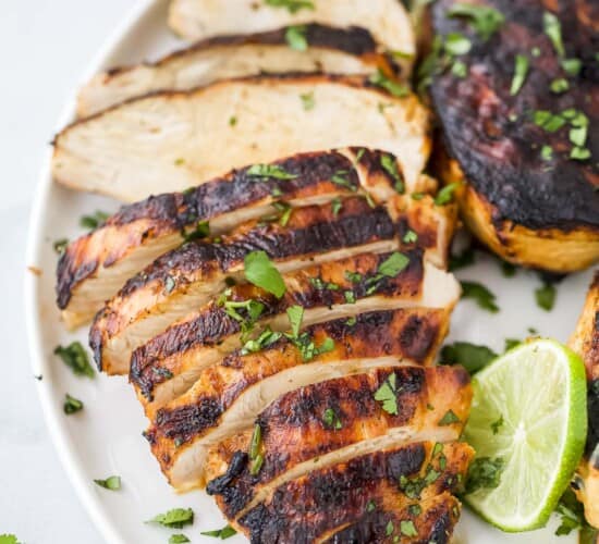 Tequila lime grilled chicken on a plate with chopped parsley sprinkled on top