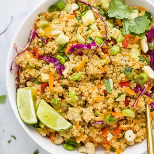 A bowl of quinoa salad on a marble countertop