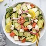 A Mediterranean salad tossed with red wine vinaigrette on a marble countertop