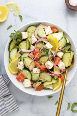 A Mediterranean salad tossed with red wine vinaigrette on a marble countertop