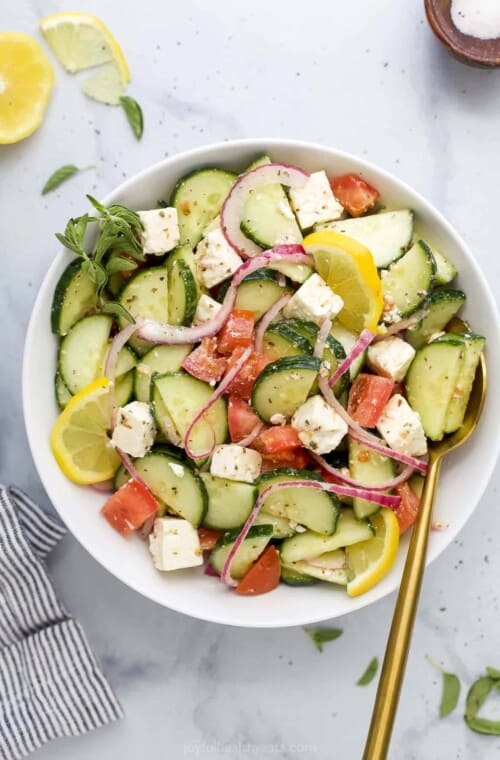 A Mediterranean salad tossed with red wine vinaigrette on a marble countertop