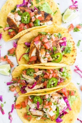 Four white fish tacos with cabbage slaw, avocado mash and chipotle lime crema