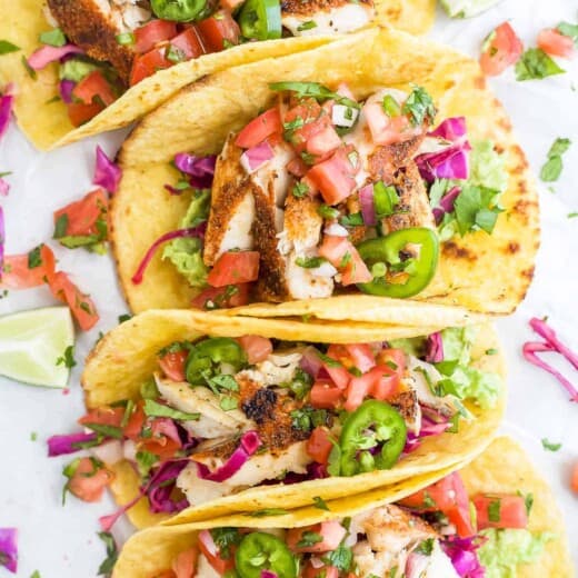 Four white fish tacos with cabbage slaw, avocado mash and chipotle lime crema