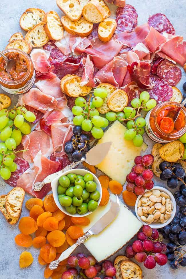 A Spanish-themed charcuterie board filled with snacks and condiments.