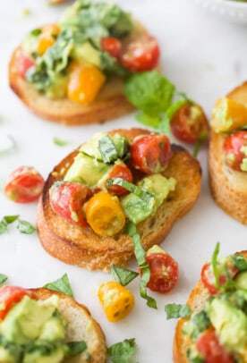 Toasted French bread topped with a tomato, basil and avocado mixture