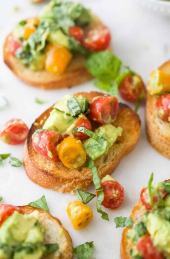 Toasted French bread topped with a tomato, basil and avocado mixture