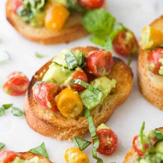 Toasted French bread topped with a tomato, basil and avocado mixture