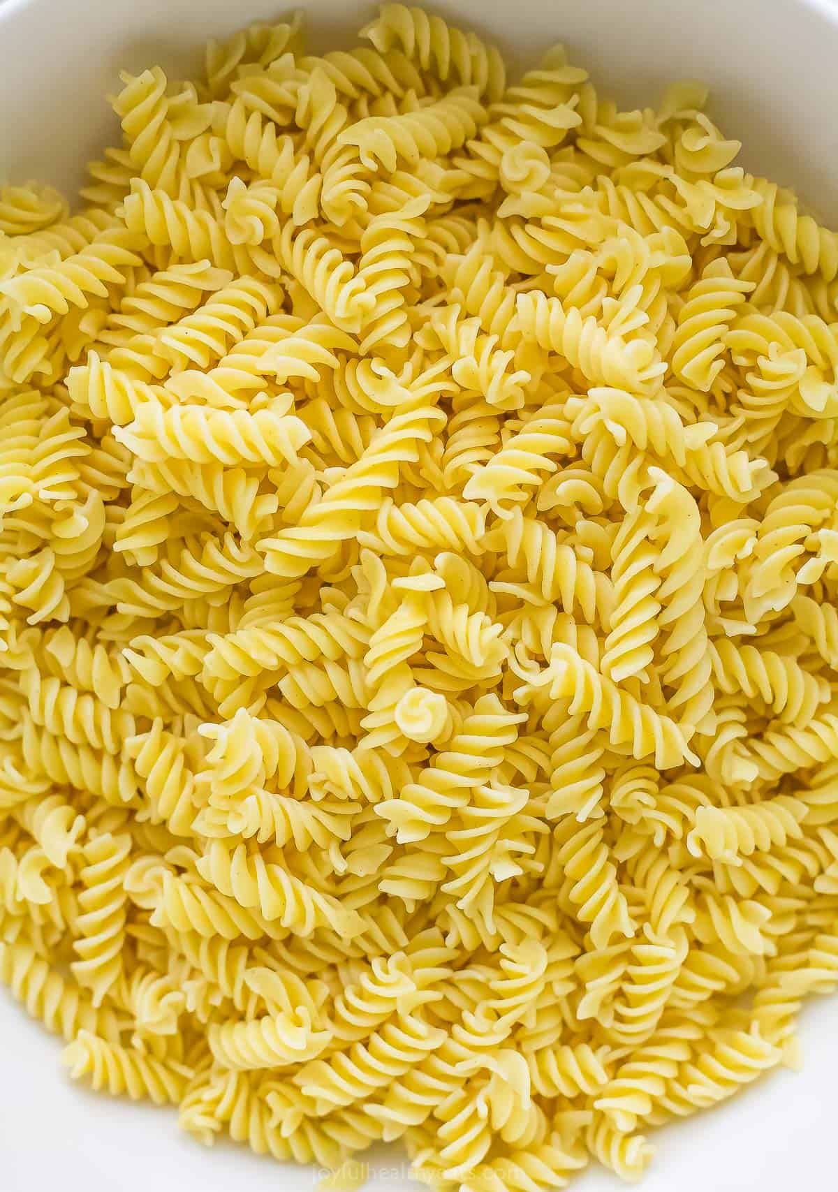 A large bowl filled with rotini pasta cooked to al dente