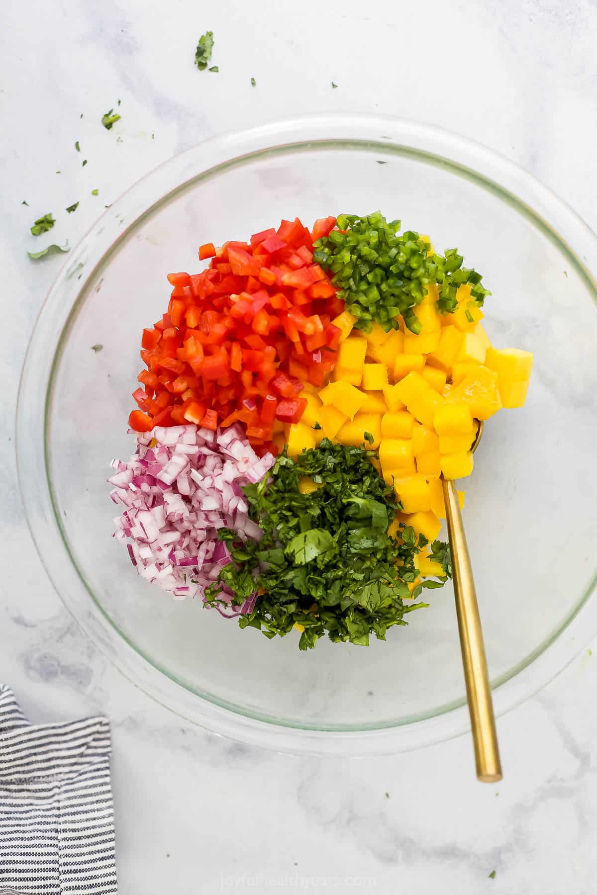 Diced red onion, finely chopped cilantro and the rest of the ingredients in a clear mixing bowl