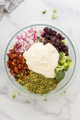 All of the salad ingredients in a bowl with the Greek yogurt dressing on top
