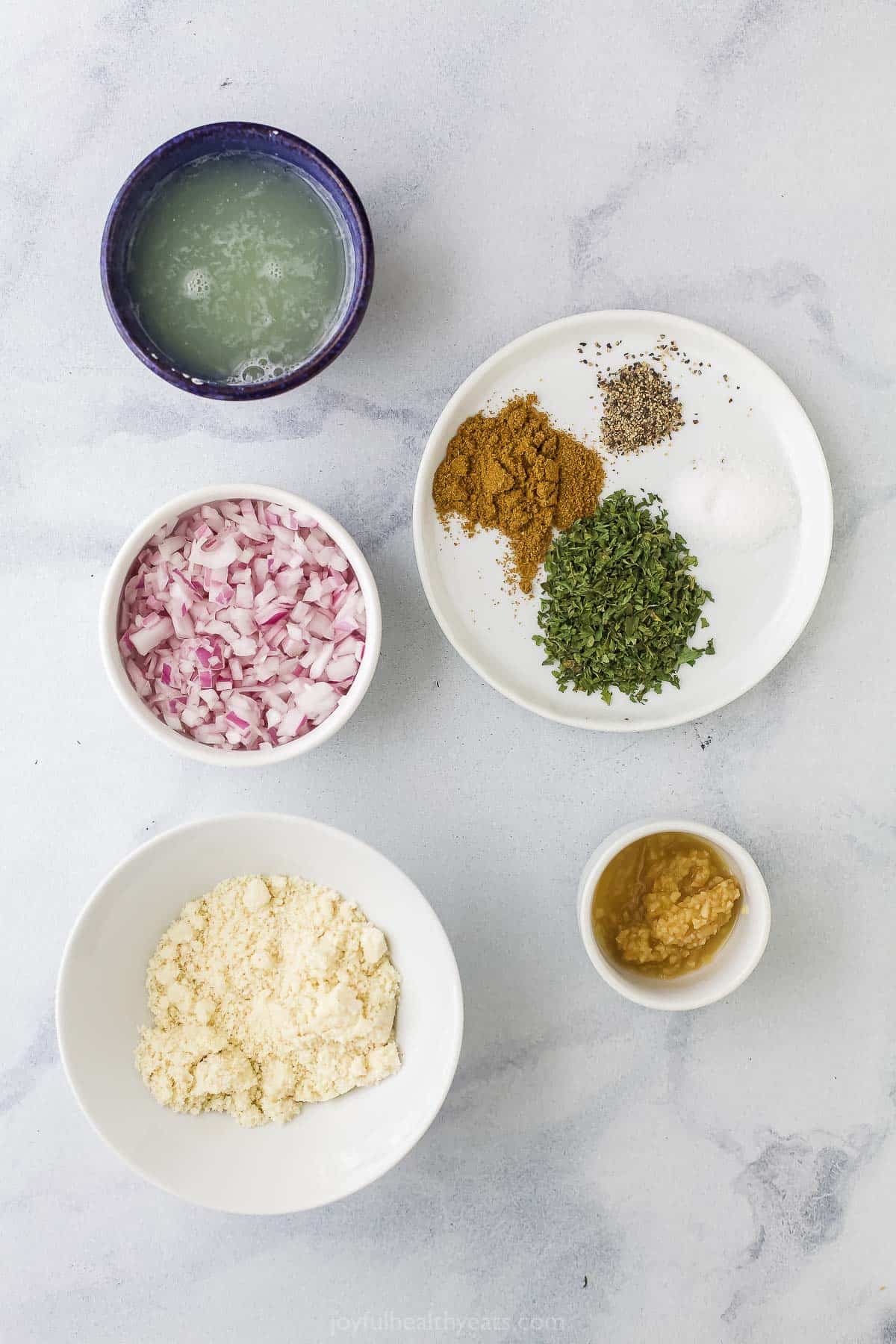 Almond flour, egg whites, freshly minced garlic and the rest of the ingredients on a marble countertop