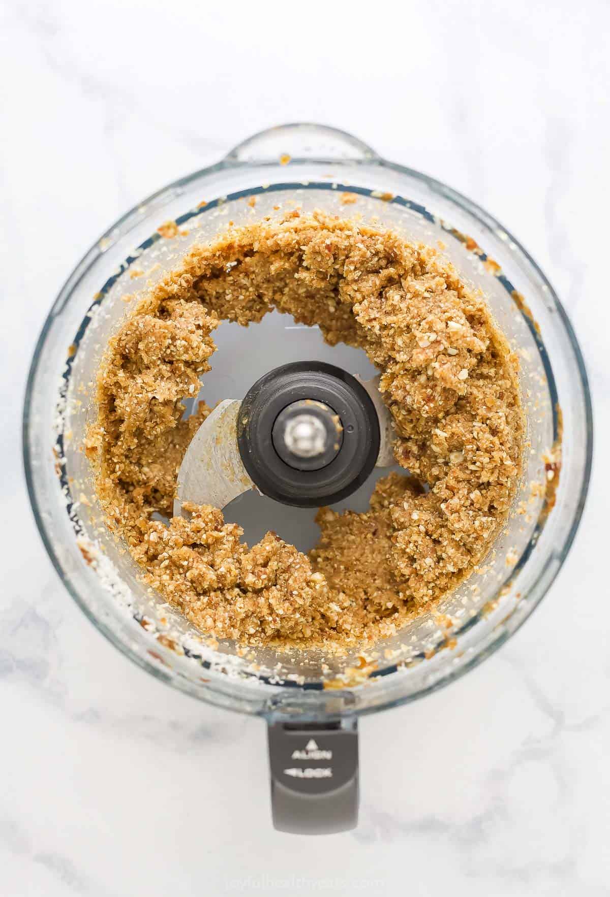 The completed protein bite dough inside of a food processor