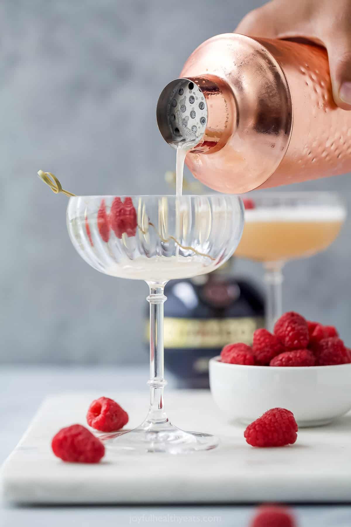 pouring a French martini into glass