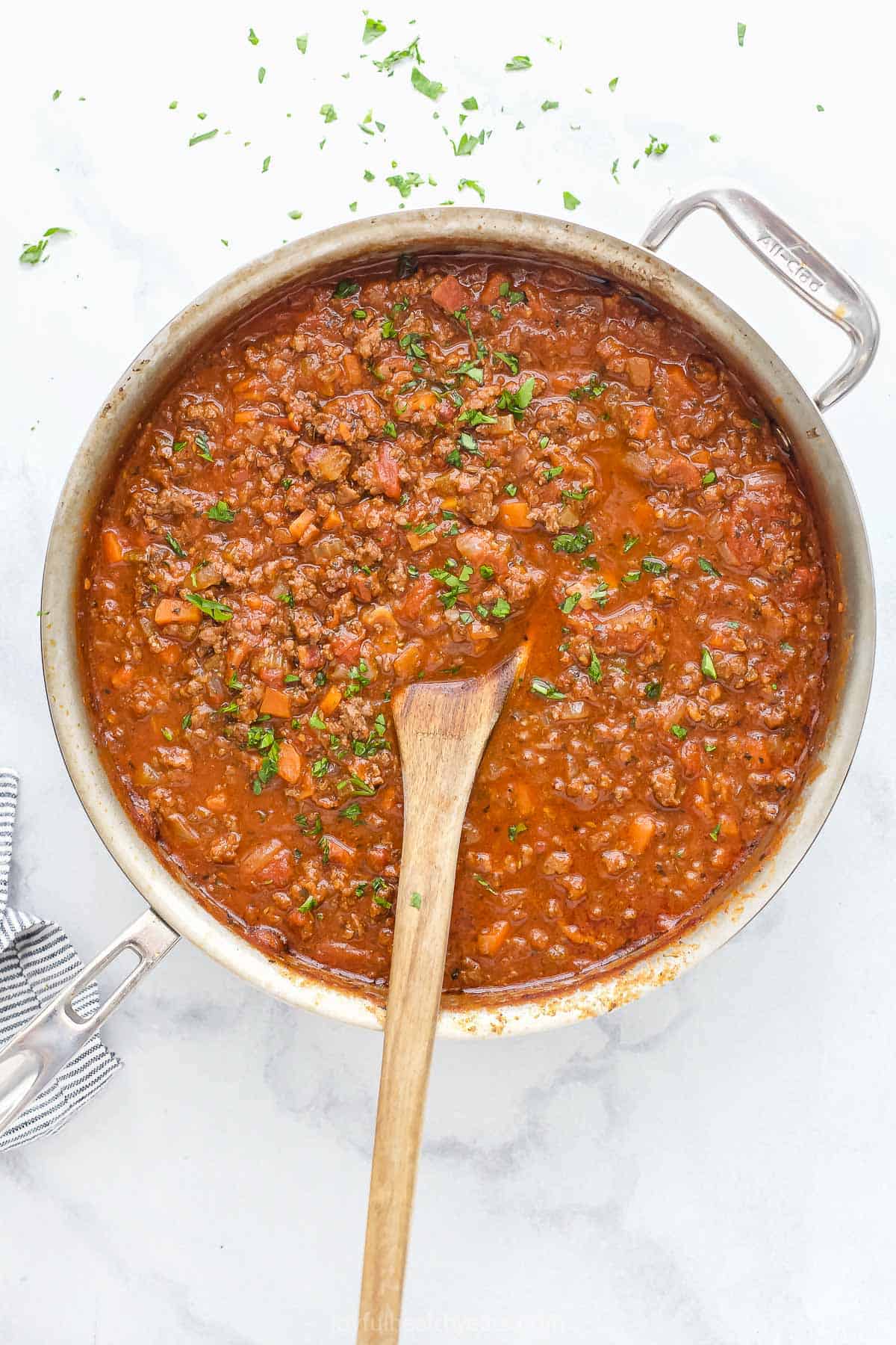 Pasta sauce simmering in pot made with beef, vegetables, and tomato sauce