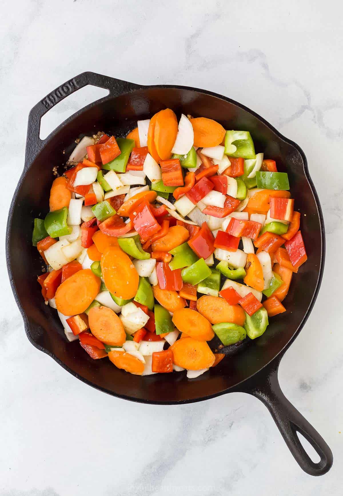 assorted chopped vegetables in a cast iron skillet