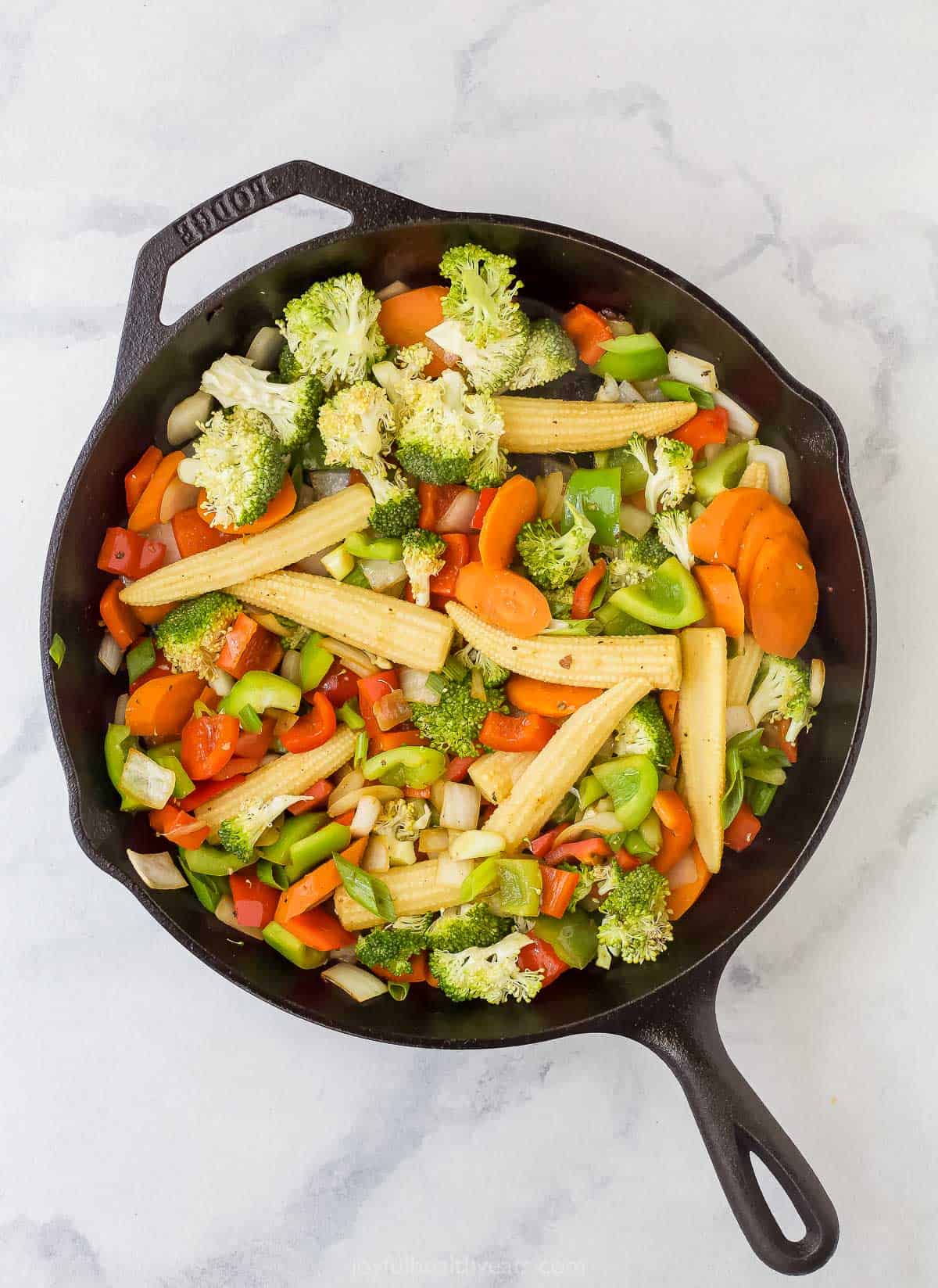 assorted chopped vegetables in a cast iron skillet