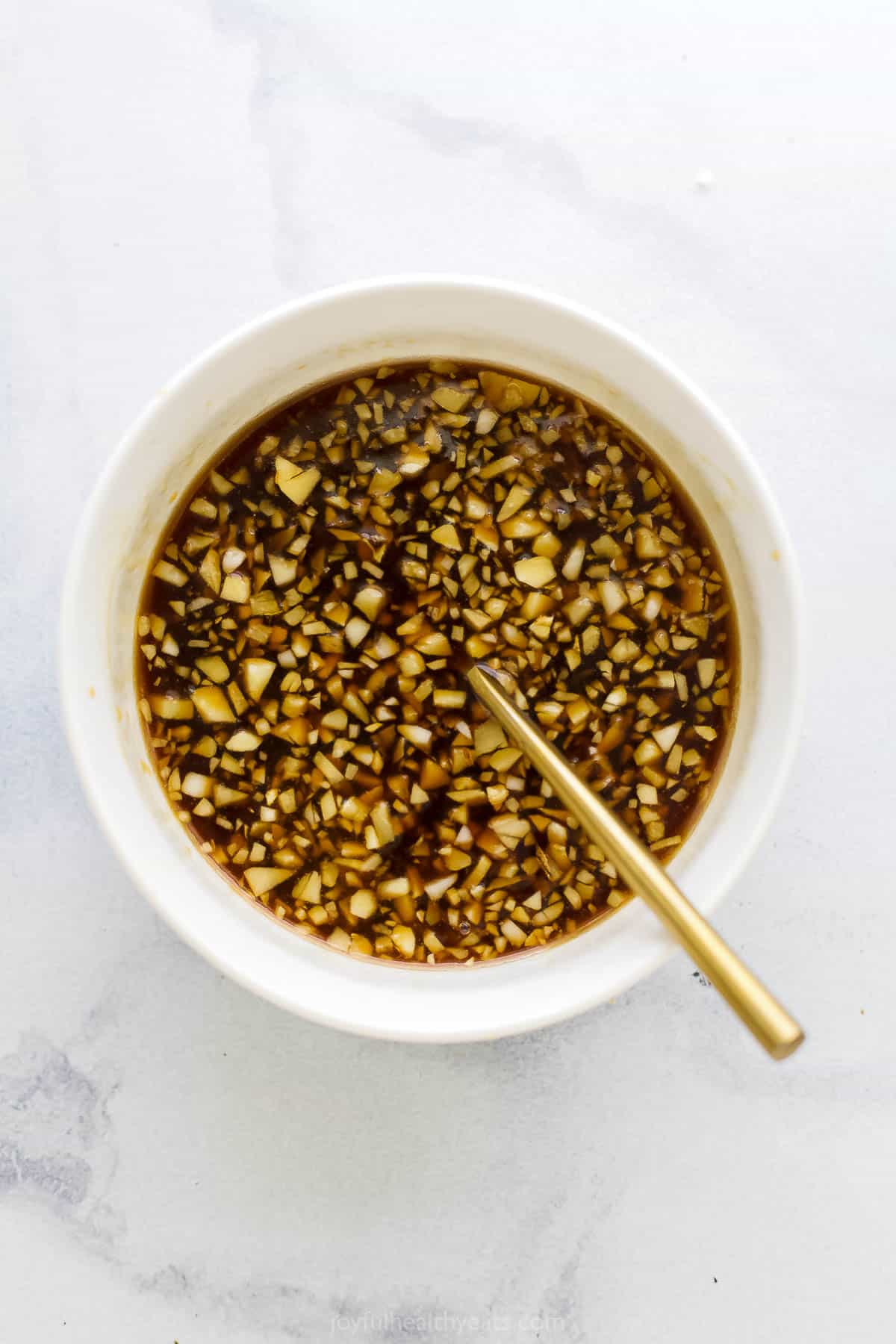 Homemade teriyaki marinade in a small dish with a golden spoon