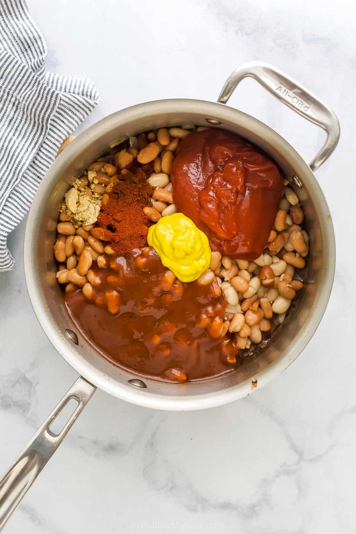 Mustard, ketchup, smoked paprika and the rest of the ingredients in a big saucepan with two handles