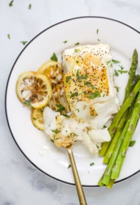 plated seared sea bass with asparagus on the side