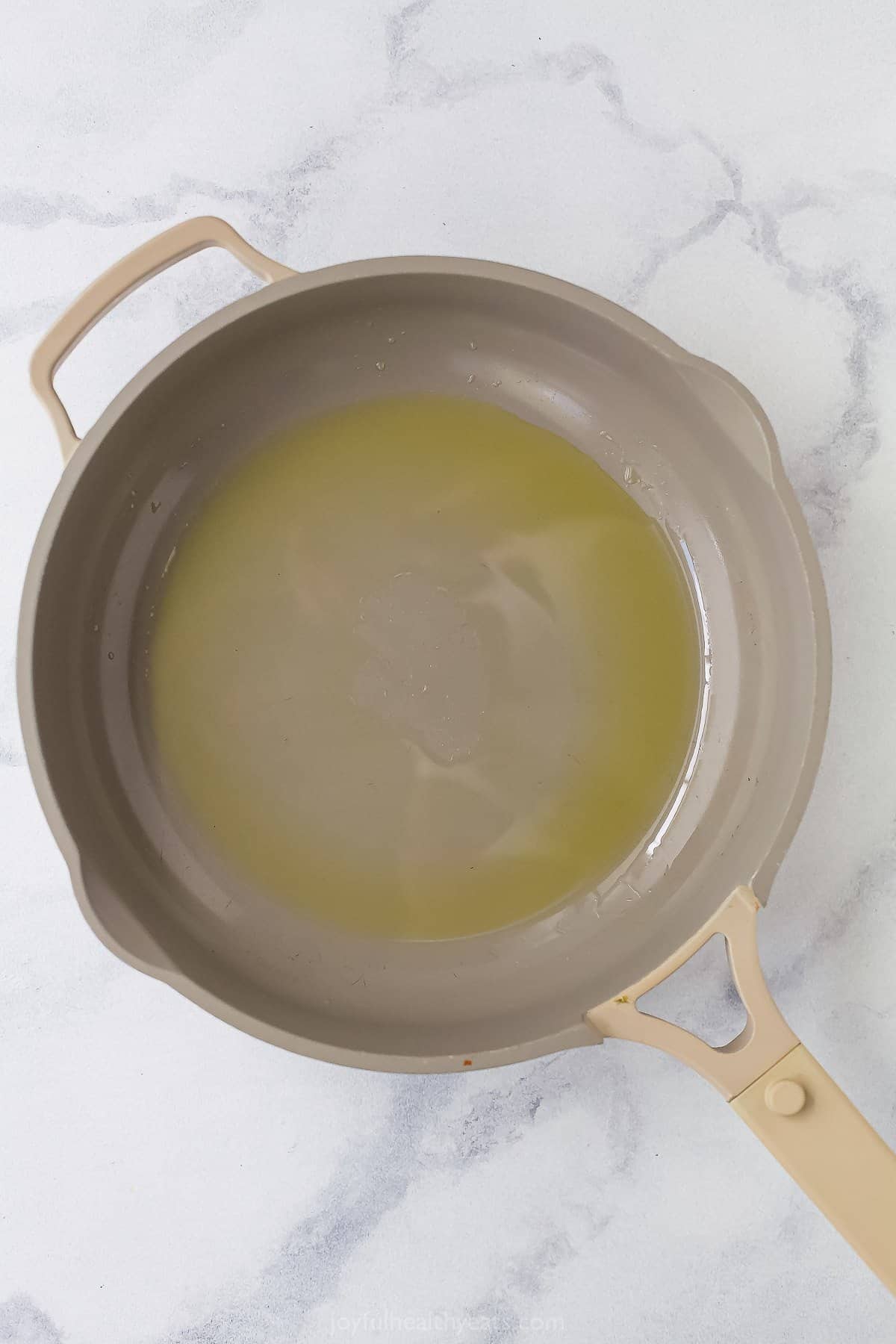 a non-stick pan with melted ghee