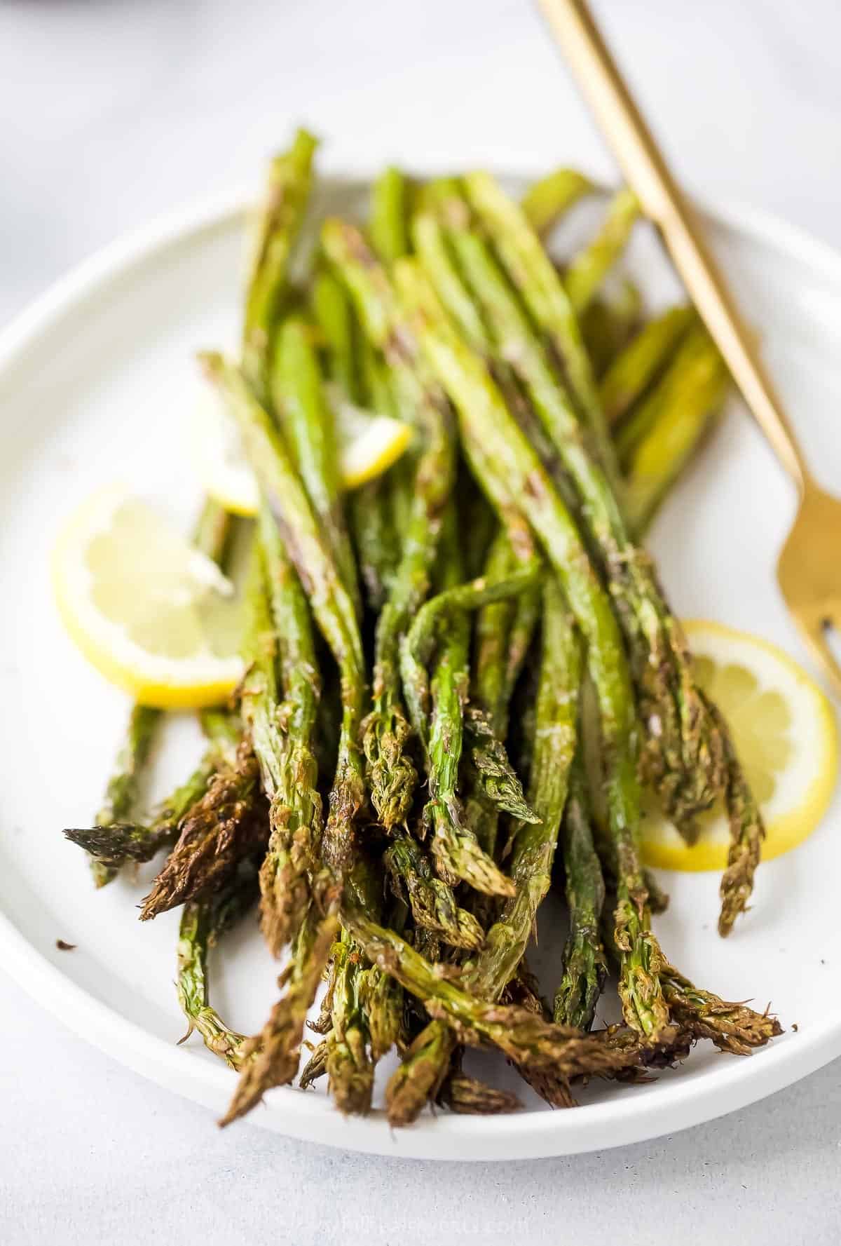 A close-up shot of a pile of Air Fryer asparagus on a serving plate