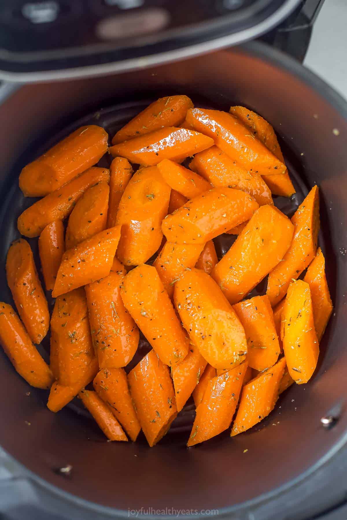 cut up carrots in an air fryer basket