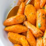 close up of roasted and seasoned carrots in a white bowl