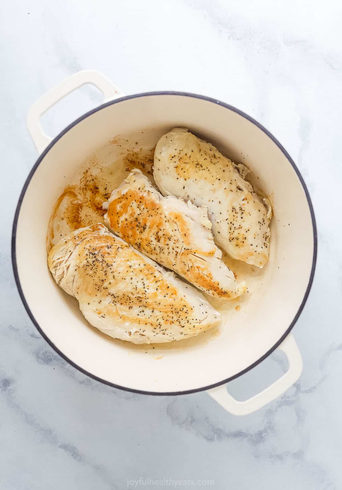 seared chicken breasts in a large pot