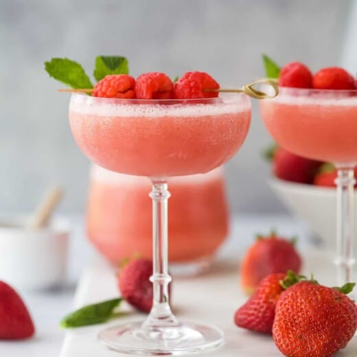 frozen rosé wine in a glass with raspberry garnish