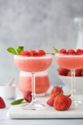 frozen rosé wine in a glass with raspberry garnish